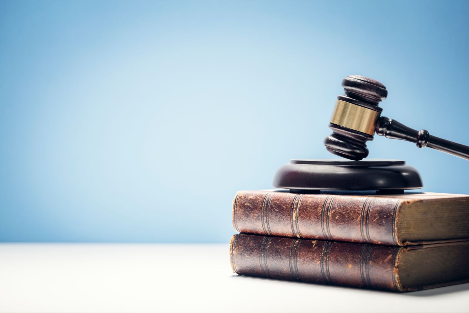 Judge Gavel And Law Books In Court Background With