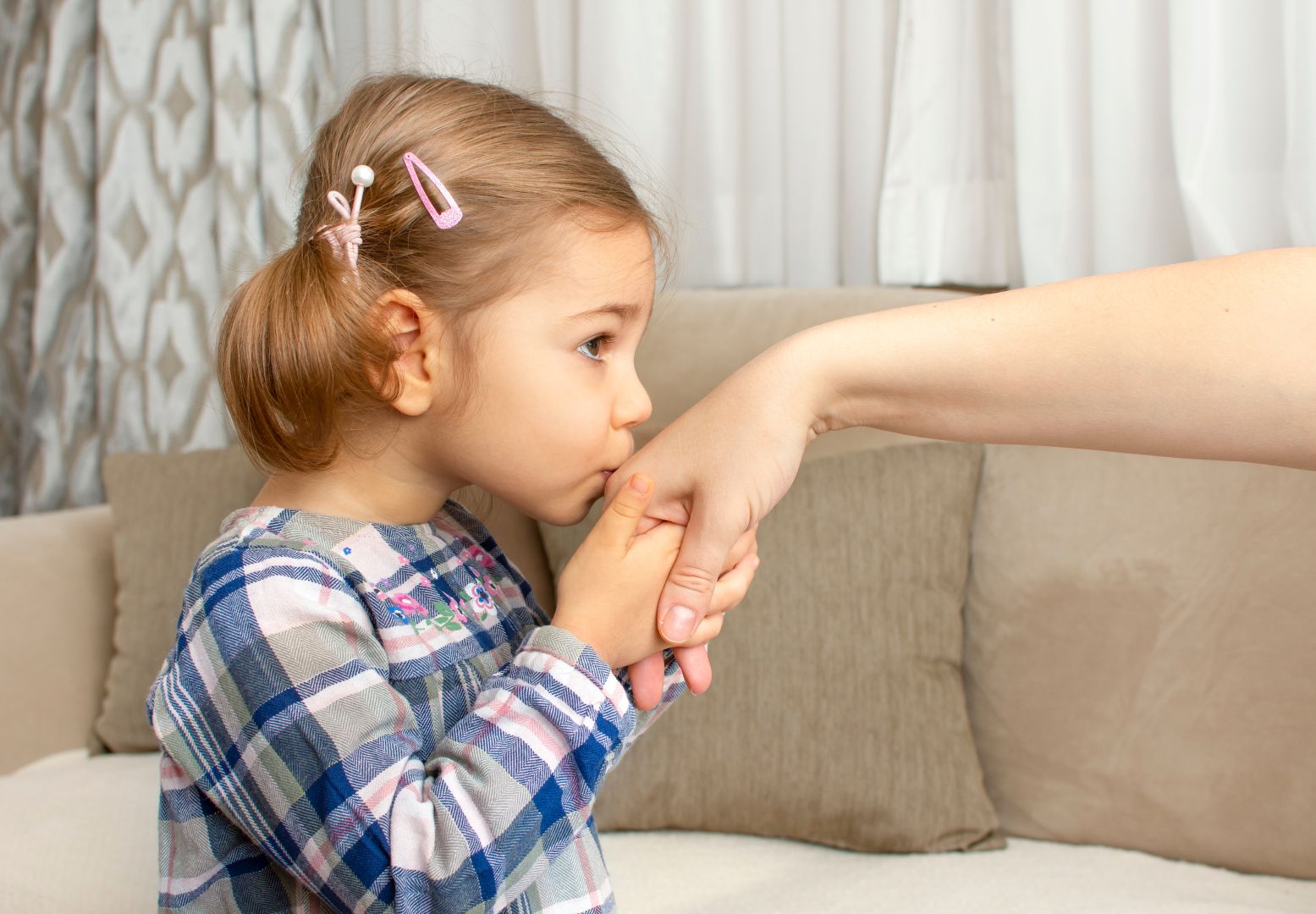 Little girl kissing her parent's hand. Muslim tradition