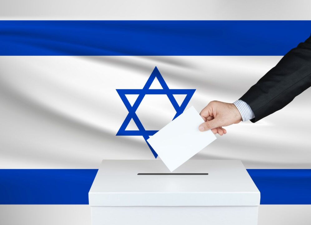 Election In Israel. The Hand Of Man Putting His Vote In The Ballot box